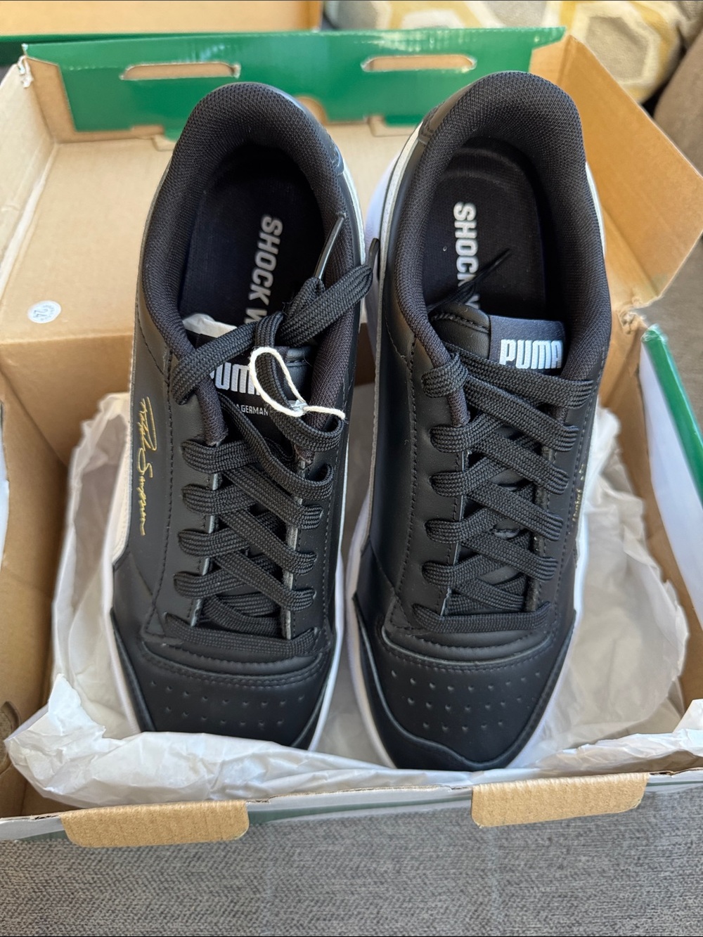 Puma Menβs Black Sneakers with Gold Accent